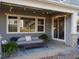Covered patio with outdoor seating, string lights, and access to backyard at 8354 Big Thompson St, Littleton, CO 80125