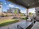 Comfortable covered patio area with stylish furniture and a view of the landscaped backyard at 8354 Big Thompson St, Littleton, CO 80125