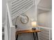 Close up of wood table and decor next to a stairway with steel cable railing system at 8354 Big Thompson St, Littleton, CO 80125