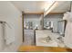 Bathroom featuring long counter and view into the carpeted bedroom with window seat at 2525 S Dayton Way # 1514, Denver, CO 80231