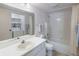 Clean white bathroom featuring a shower/tub combo, single sink vanity, and a mirrored wall at 2525 S Dayton Way # 1514, Denver, CO 80231