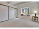 Bright bedroom with large window seat, neutral carpet, and large closets at 2525 S Dayton Way # 1514, Denver, CO 80231