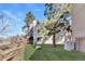A modern apartment building features grassy lawn and mature trees in a suburban neighborhood at 2525 S Dayton Way # 1514, Denver, CO 80231