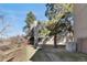 The back exterior of the building shows green space and a walking path along the back of the home at 2525 S Dayton Way # 1514, Denver, CO 80231