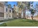 Exterior view of a well-maintained apartment building with lush lawn and mature trees and easy path at 2525 S Dayton Way # 1514, Denver, CO 80231