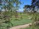 Scenic view of the golf course with lush greens and mountain views in the distance at 2525 S Dayton Way # 1514, Denver, CO 80231