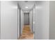Hallway with wood floors and neutral colored walls leading to various rooms at 2525 S Dayton Way # 1514, Denver, CO 80231
