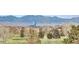 Scenic views of the Rocky Mountains overlooking mature trees and a lush, green golf course in foreground at 2525 S Dayton Way # 1514, Denver, CO 80231