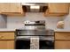 Close-up view of a stainless steel oven in kitchen with tile backsplash at 2525 S Dayton Way # 1514, Denver, CO 80231