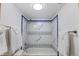 This bathroom shower features decorative tiling and bright lighting at 2525 S Dayton Way # 1514, Denver, CO 80231