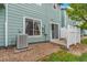 View of the backyard featuring a patio and central air conditioning system at 5895 Biscay St # D, Denver, CO 80249