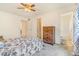 The bedroom includes a wood dresser and a view into the bathroom at 5895 Biscay St # D, Denver, CO 80249