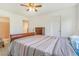 Bedroom featuring a wood sleigh bed, ceiling fan, and access to an ensuite bathroom at 5895 Biscay St # D, Denver, CO 80249