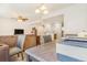 Spacious living area featuring a modern design, including a comfortable sofa, dining area, and natural light at 5895 Biscay St # D, Denver, CO 80249