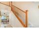 Elegant staircase with wooden banister, white risers, and views of the living area below, creating a seamless flow at 5895 Biscay St # D, Denver, CO 80249