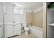 Bathroom with single sink vanity, framed mirror, and shower-tub combination at 8701 E Briarwood Blvd, Centennial, CO 80112