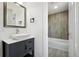 Stylish bathroom featuring a modern vanity with a square sink and a tub with gray vertical tiling at 8701 E Briarwood Blvd, Centennial, CO 80112