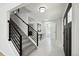 Bright and airy foyer with modern staircase, stylish tile flooring, and a welcoming entrance at 8701 E Briarwood Blvd, Centennial, CO 80112