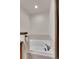 Bathroom features a corner soaking tub, faucet, towel rack, and marble tiling at 2972 W Long Dr # C, Littleton, CO 80120