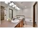 Primary bathroom features double sinks, vanity lighting, and a tub at 2972 W Long Dr # C, Littleton, CO 80120