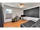 This room features wood floors, a ceiling fan, a chalkboard accent wall, and a futon at 2972 W Long Dr # C, Littleton, CO 80120