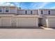 Street view of garages with neutral siding, highlighting convenient parking and curb appeal at 2972 W Long Dr # C, Littleton, CO 80120
