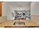 Granite countertops with stainless sink overlooking dining area and backyard at 2972 W Long Dr # C, Littleton, CO 80120