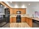 Kitchen with stainless steel appliances, wooden cabinets, and a subway tile backsplash at 2972 W Long Dr # C, Littleton, CO 80120