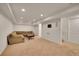 Spacious living room with neutral carpet, recessed lighting, and a large brown couch at 2972 W Long Dr # C, Littleton, CO 80120