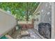 Inviting outdoor patio space, complete with comfortable seating, a grill, and a shade tree at 2972 W Long Dr # C, Littleton, CO 80120