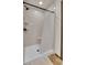 Bathroom features a walk-in shower with a white shower curtain and light stone-look shower surround at 2972 W Long Dr # C, Littleton, CO 80120