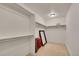 Large walk-in closet with metal shelving, carpeted floors, and ample storage space at 2972 W Long Dr # C, Littleton, CO 80120