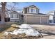 Two-story house with a large yard and attached two-car garage at 5593 S Himalaya Way, Centennial, CO 80015