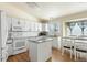 Kitchen with white cabinets, granite countertops, and an island at 5593 S Himalaya Way, Centennial, CO 80015