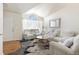 Spacious living room with white couches and a view into the kitchen at 5593 S Himalaya Way, Centennial, CO 80015