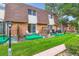 Outdoor patio area with green grass, planting area, and partial brick privacy fence at 1200 S Monaco St Pkwy # 31, Denver, CO 80224