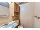 Cozy powder room featuring a classic vanity, mirror and overhead cabinet at 1200 S Monaco St Pkwy # 31, Denver, CO 80224