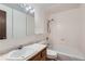 Bathroom featuring a vanity and shower-tub combo with tiled walls at 1200 S Monaco St Pkwy # 31, Denver, CO 80224