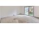 Spacious bedroom featuring a sliding door to a balcony and neutral carpeting at 1200 S Monaco St Pkwy # 31, Denver, CO 80224