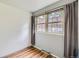 Well-lit bedroom with a large window and wood flooring at 1200 S Monaco St Pkwy # 31, Denver, CO 80224