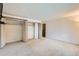 Bedroom featuring a mounted TV, neutral carpet, and large closet space at 1200 S Monaco St Pkwy # 31, Denver, CO 80224