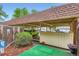 Comfortable carport area with lush greenery and mature trees at 1200 S Monaco St Pkwy # 31, Denver, CO 80224