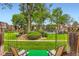 View from the rear patio of the grassy common area, landscaping, and neighborhood pool at 1200 S Monaco St Pkwy # 31, Denver, CO 80224