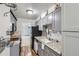 Updated kitchen with gray cabinets, stainless steel appliances, and views to the living room at 1200 S Monaco St Pkwy # 31, Denver, CO 80224