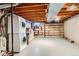 Unfinished laundry room with washer and dryer hookups and wood shelving at 1200 S Monaco St Pkwy # 31, Denver, CO 80224