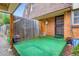 Cozy private patio area with green turf, brick accents, and a wooden fence at 1200 S Monaco St Pkwy # 31, Denver, CO 80224