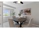 Cozy dining room features a round table, elegant chairs, modern lighting, and a large window, creating an inviting atmosphere at 3222 S Fairfax St, Denver, CO 80222