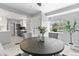 Bright dining room with modern lighting, an inviting table setting, and an open view to the updated kitchen at 3222 S Fairfax St, Denver, CO 80222