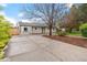 Charming home with a well-manicured front yard and a concrete driveway at 3222 S Fairfax St, Denver, CO 80222