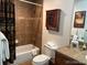 Cozy bathroom featuring tiled shower-tub, toilet, and rustic vanity with neutral counter top at 34 Highfield Trl # 212, Breckenridge, CO 80424